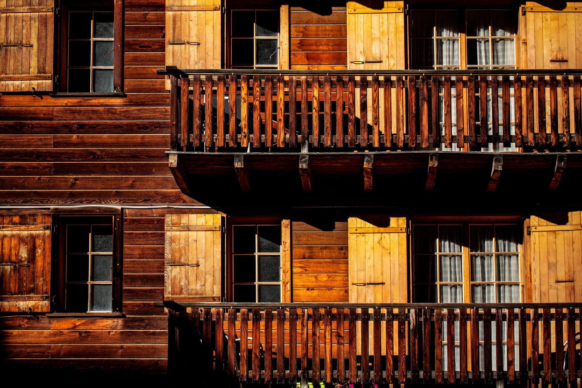 A wooden building with lots of windows and balconies.