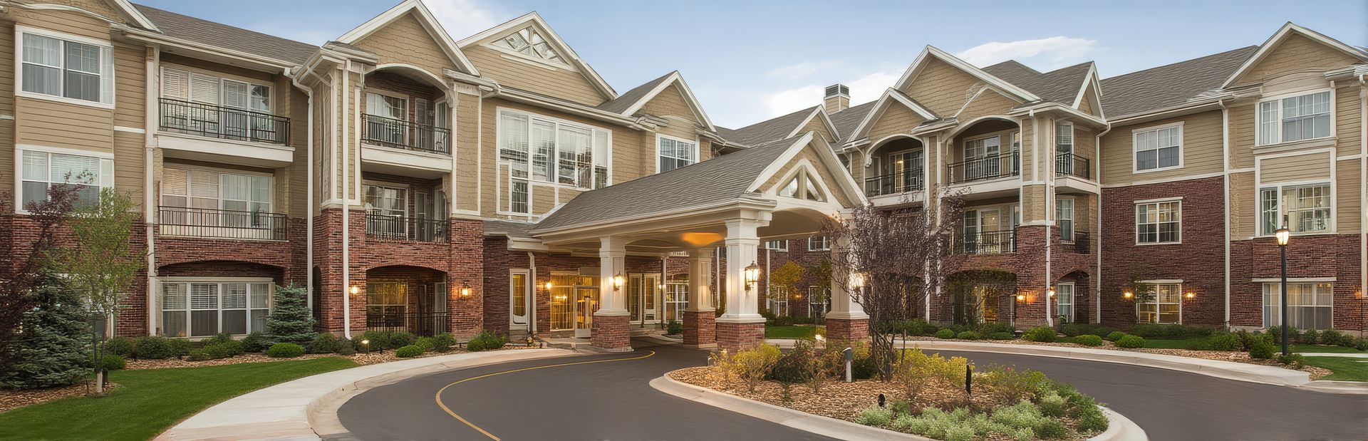 Welcoming entrance of a modern assisted living complex surrounded by elegant landscaping. Welcoming entrance of a modern assisted living complex surrounded by elegant landscaping.