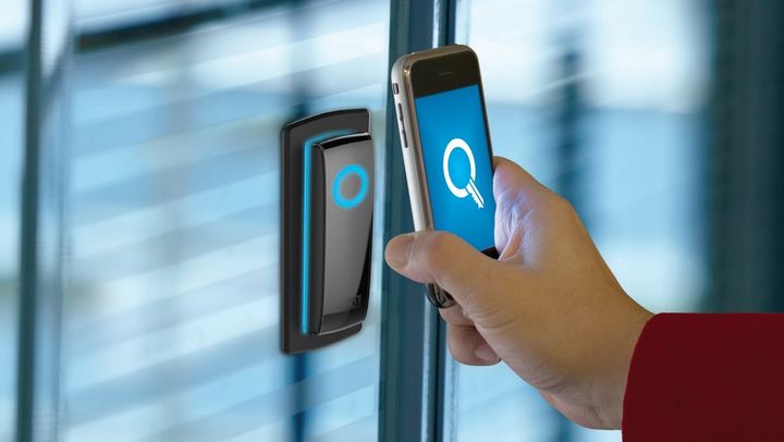 A person is using a smart phone to unlock a door