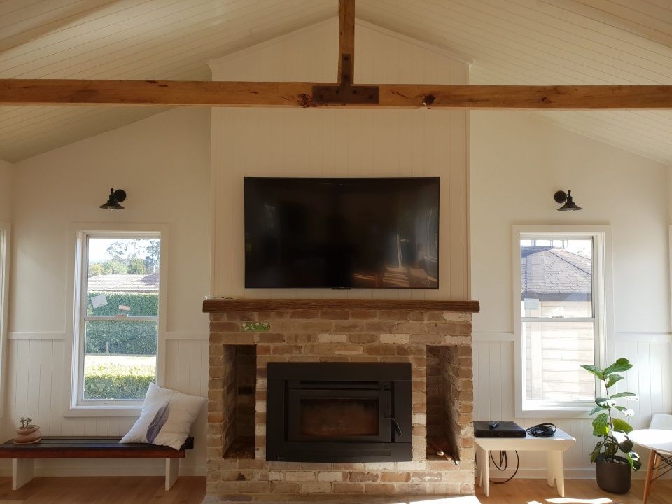 A living room with a fireplace and a flat screen TV.