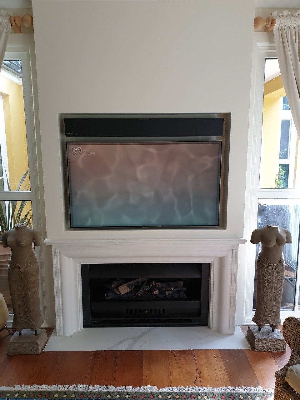 A living room with a fireplace and a television