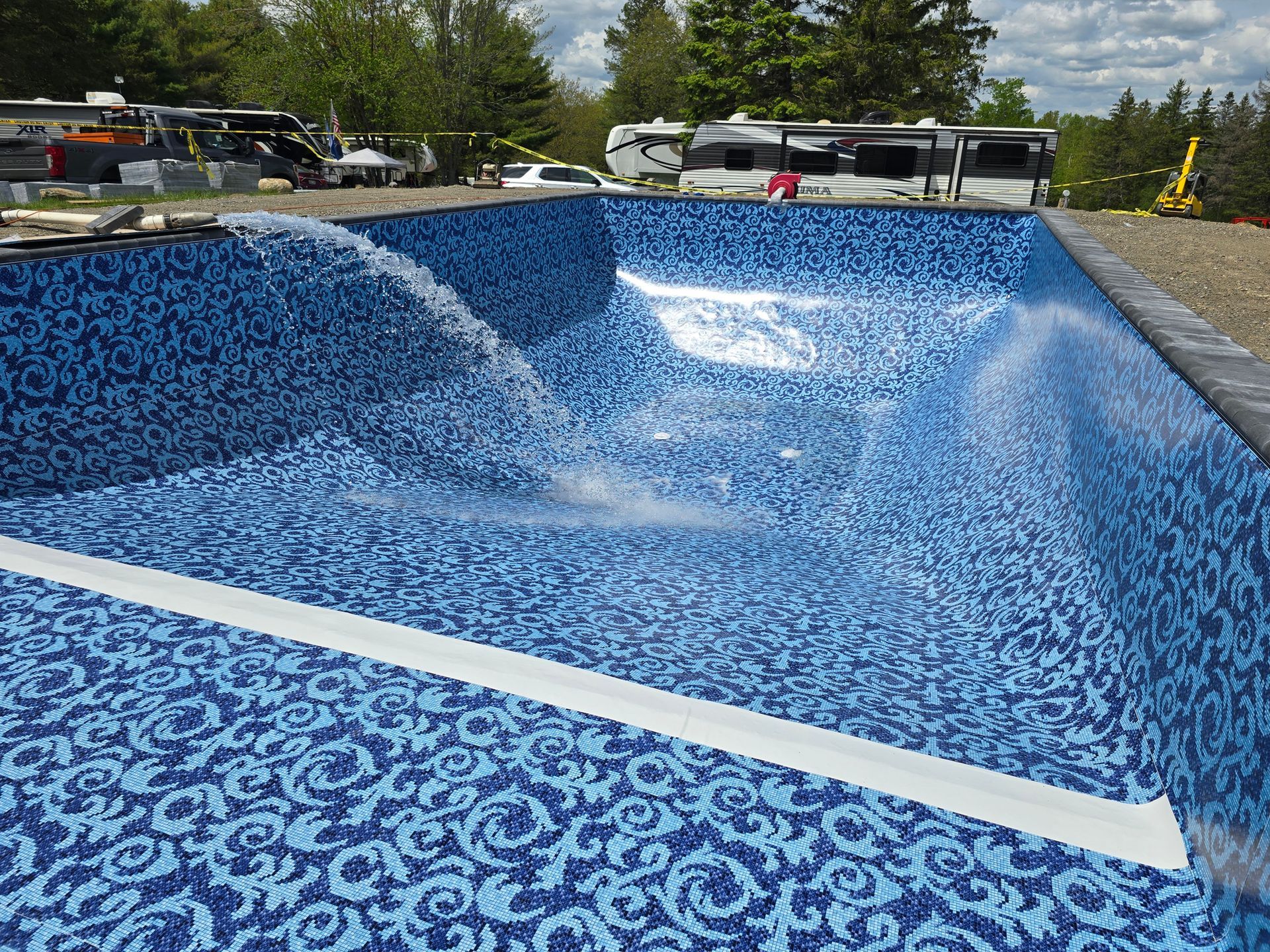 A swimming pool with blue tiles and a white line in the middle