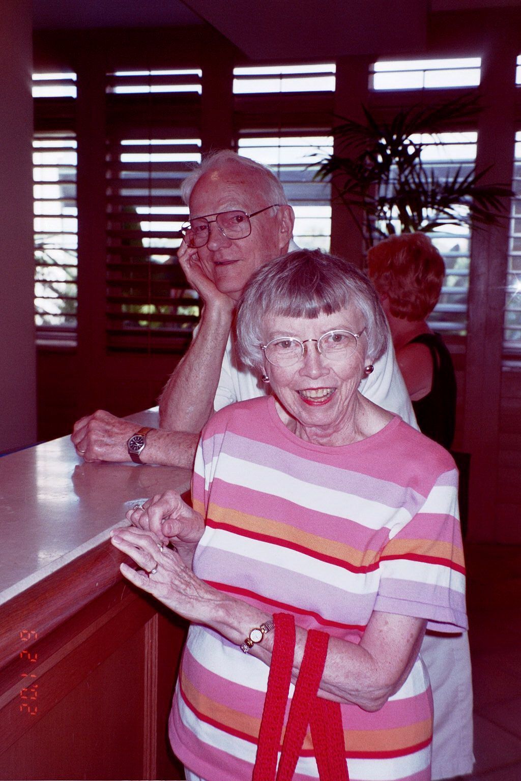 A man and a woman are standing next to each other in a room.