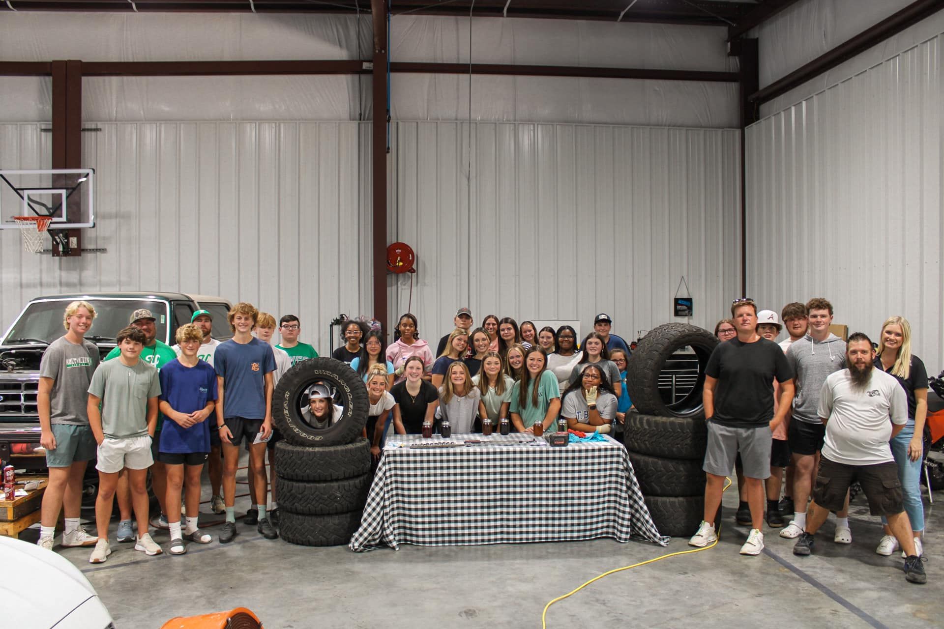 A group of people are posing for a picture in a garage.