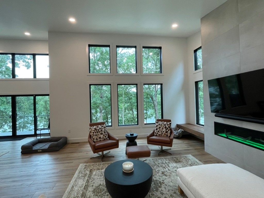 A living room with a couch , chair , coffee table and television.