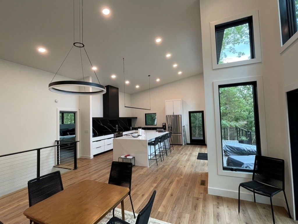 There is a table and chairs in the middle of the room.