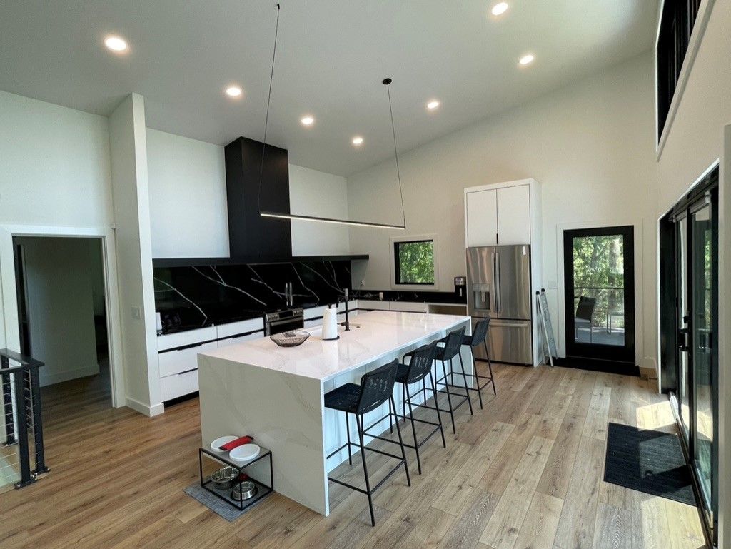 A large kitchen with a large island and stools