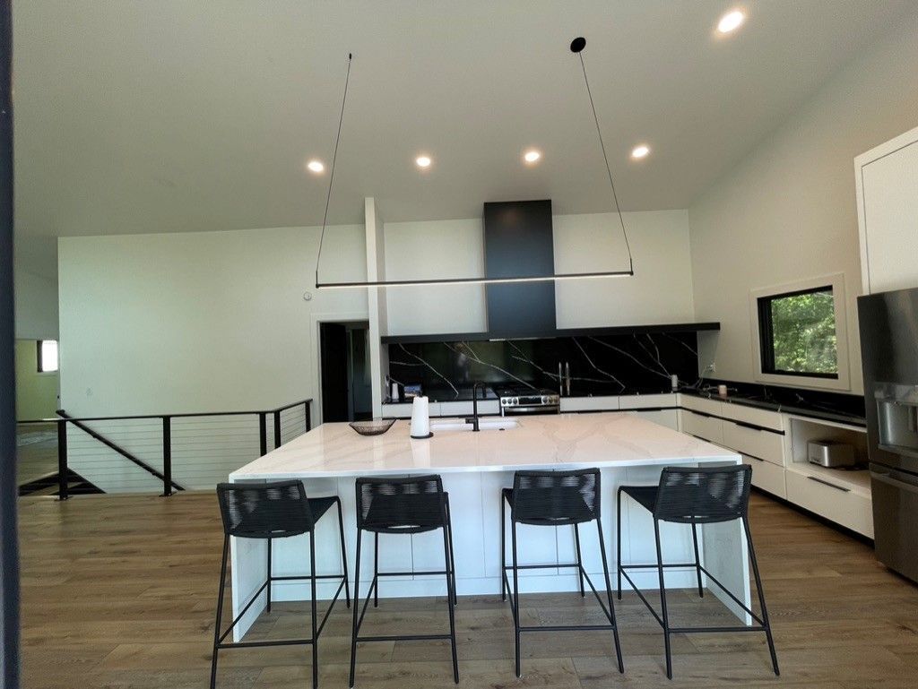 A kitchen with a large island and stools