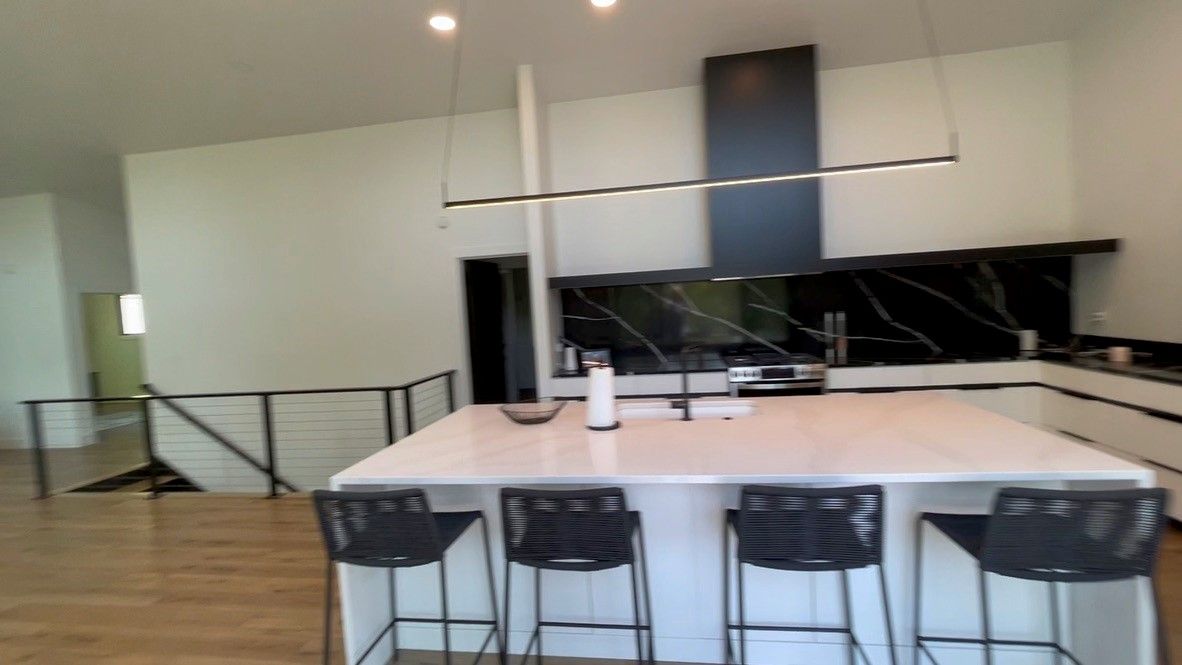 A kitchen with a large island and stools