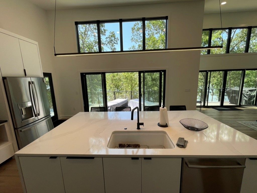 A kitchen with a large island and a sink.