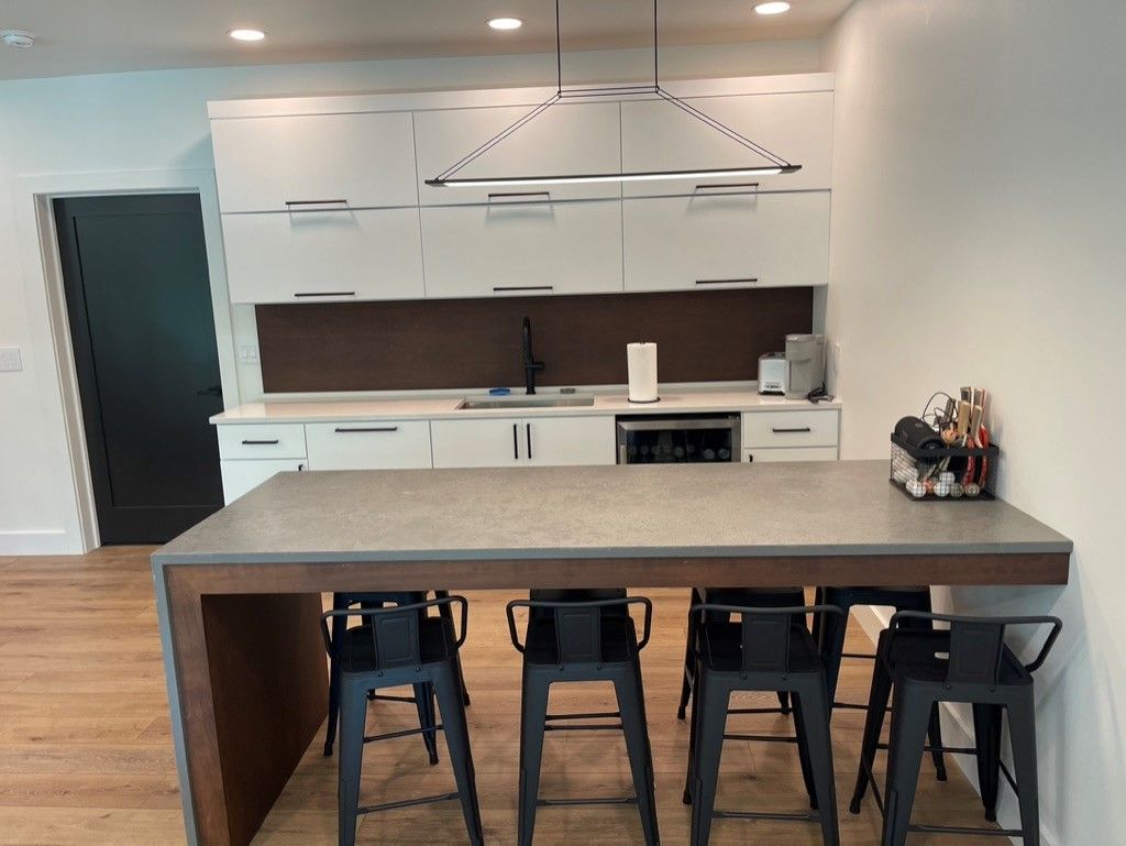 A kitchen with a large island and stools