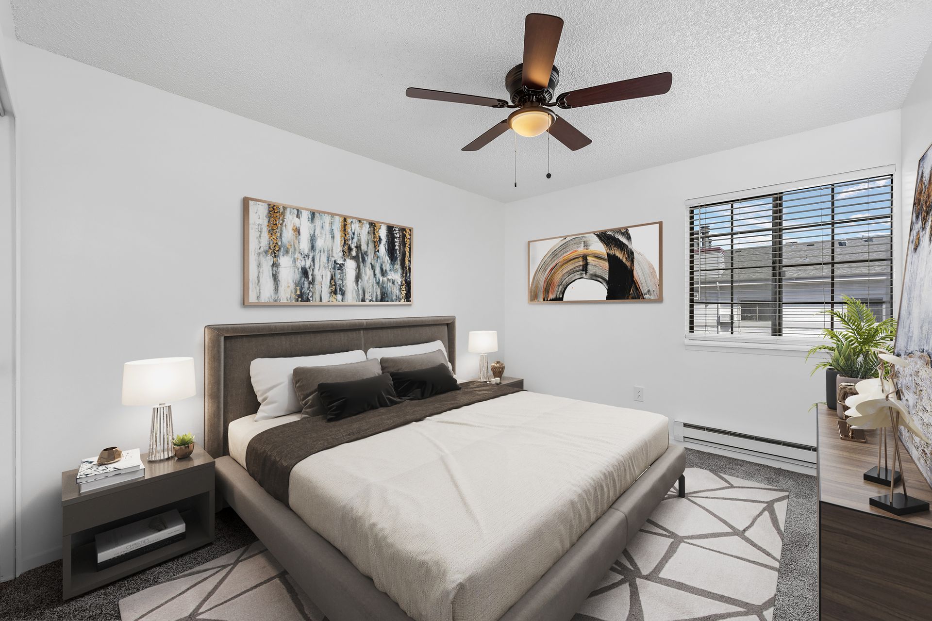 Photo showing a carpeted bedroom with a ceiling fan