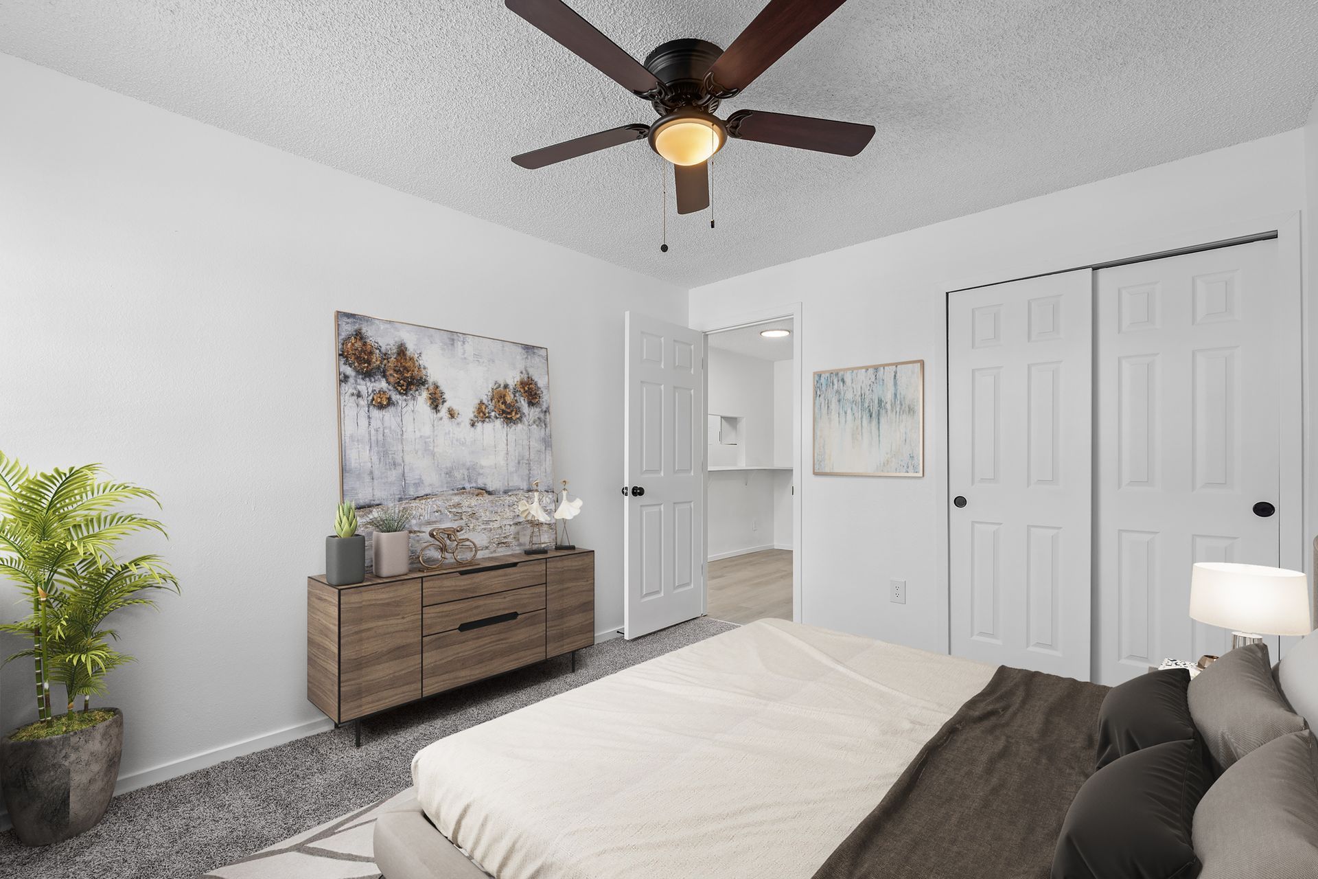 Photo showing a bedroom with the hallway in the background