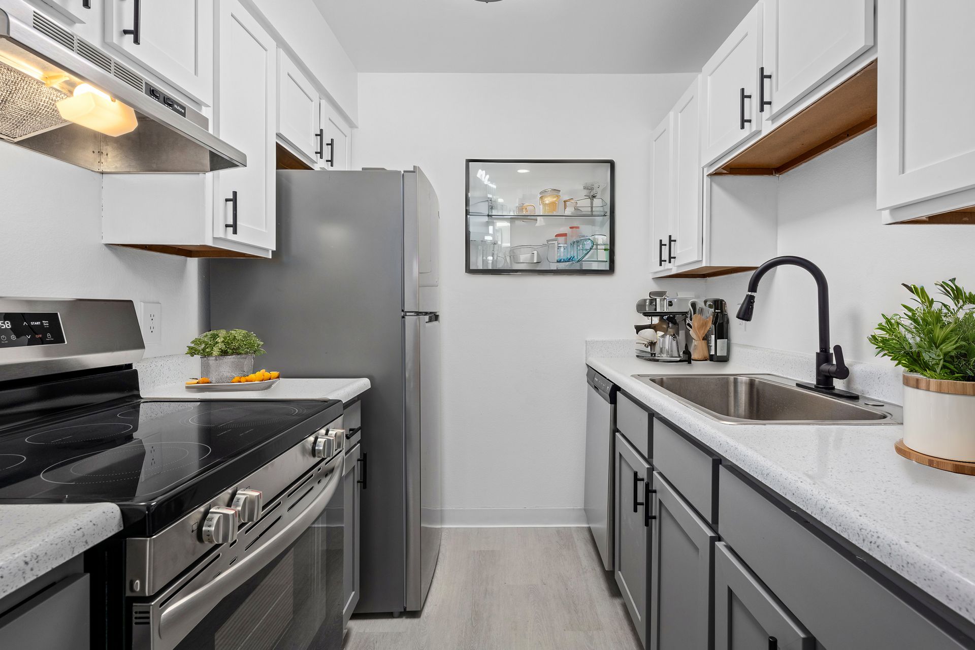 Photo showing a cozy kitchen with contemporary features like dark gray cabinetry and quartz-like countertops