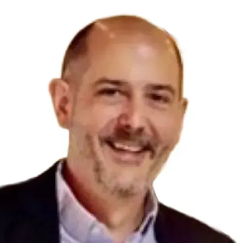 Smiling bald man in a dark jacket and light shirt against a white background