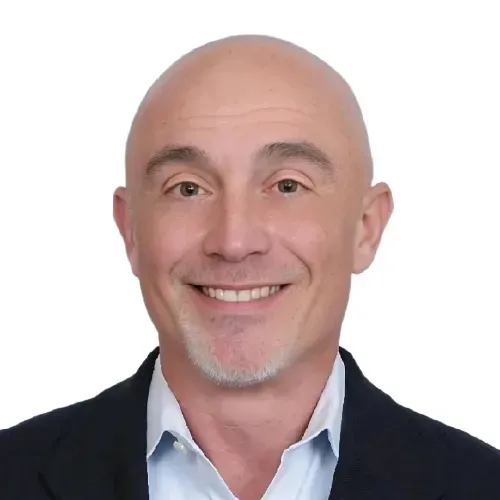 Smiling bald man in a dark blazer and light blue shirt on a white background