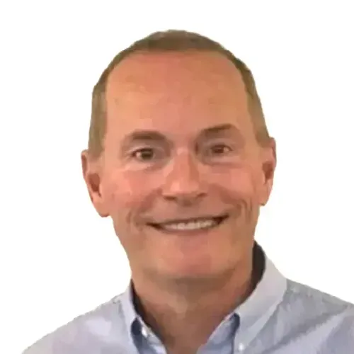 Headshot of a smiling person in a light blue shirt against a white background
