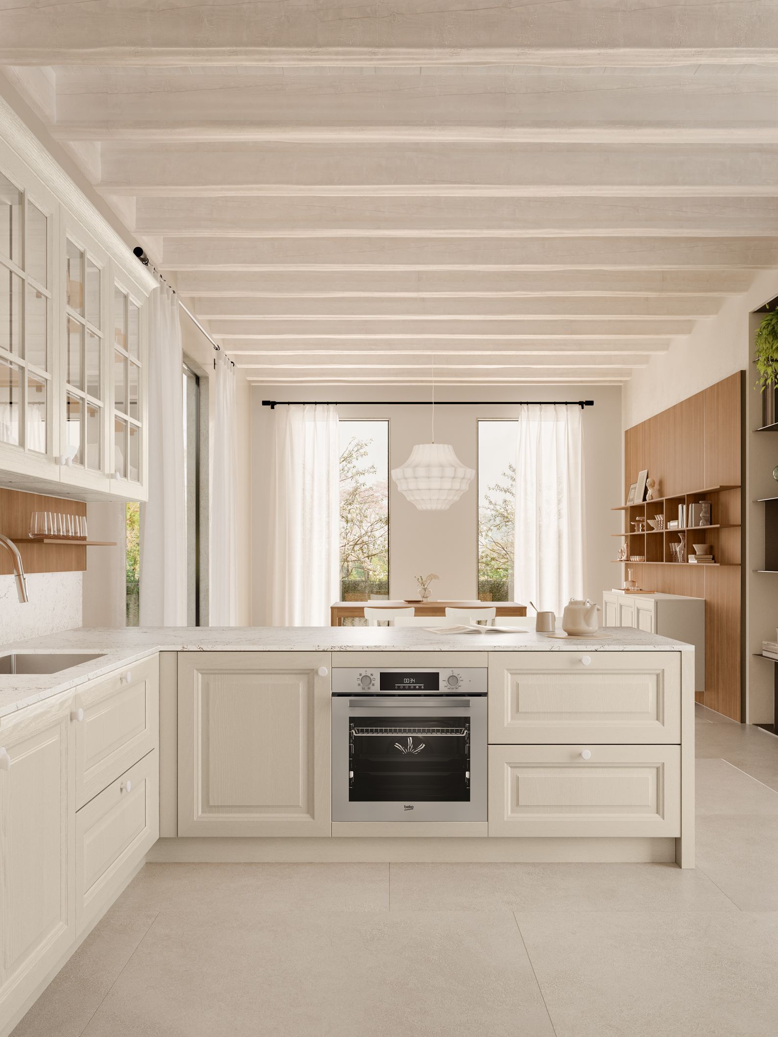 Cucina color crema con forno, mobili e vista sulla zona pranzo con finestra.