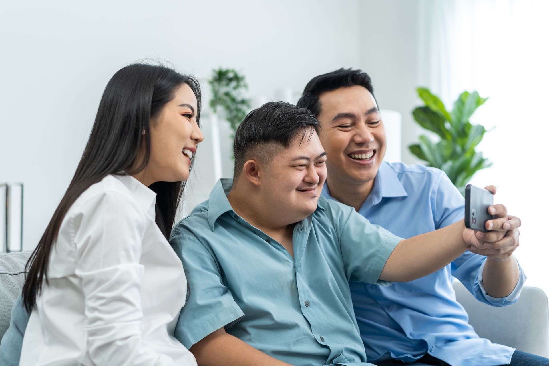 Parents and their young son are using a video call for an online children's continence consultation.