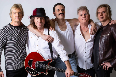 Five men dressed as members of Queen, posing for a photo.