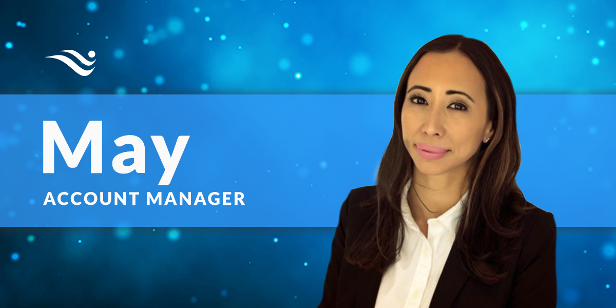 May, account manager, smiling in a dark blazer on a blue background