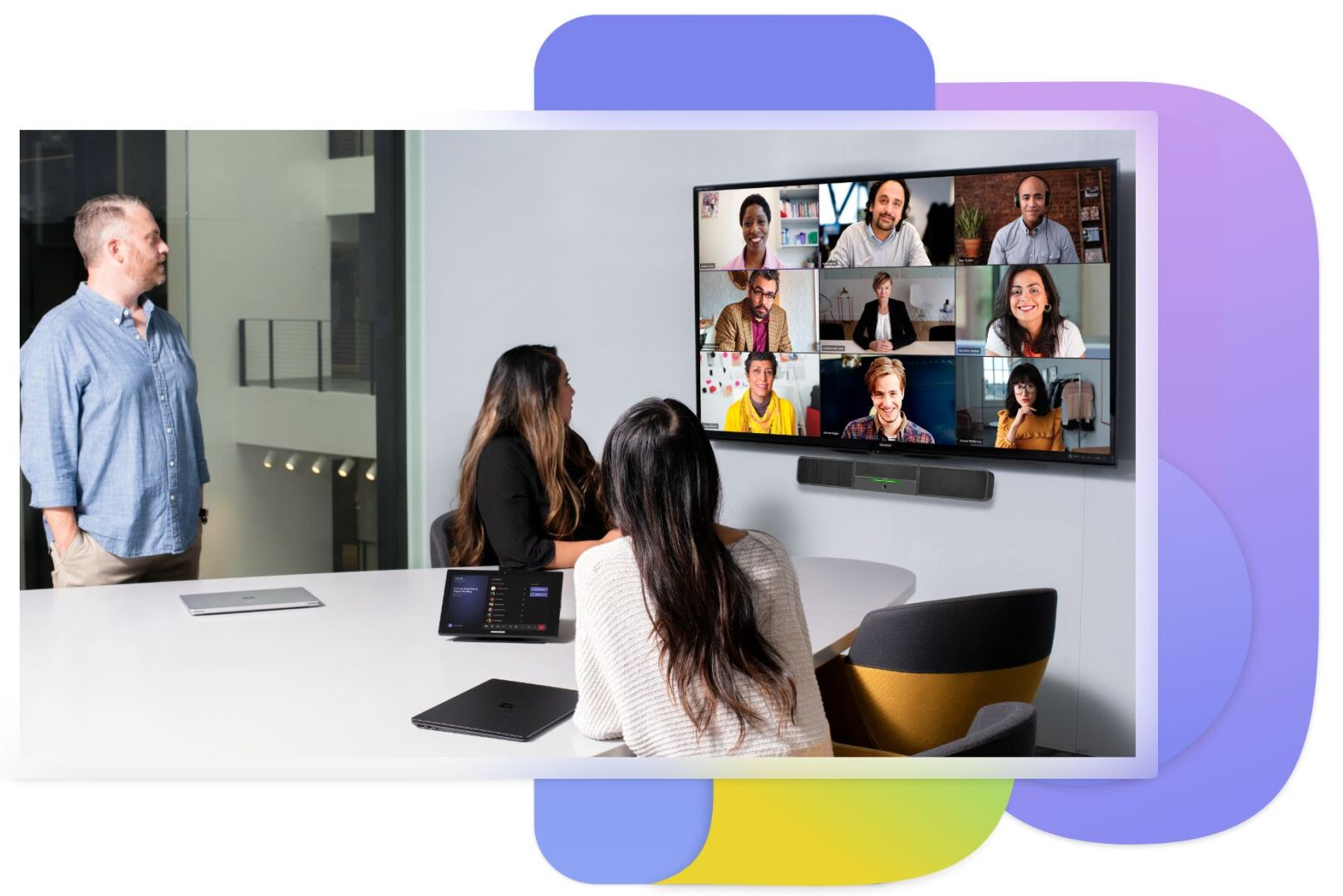 Conference room with people video chatting on a large screen during a meeting