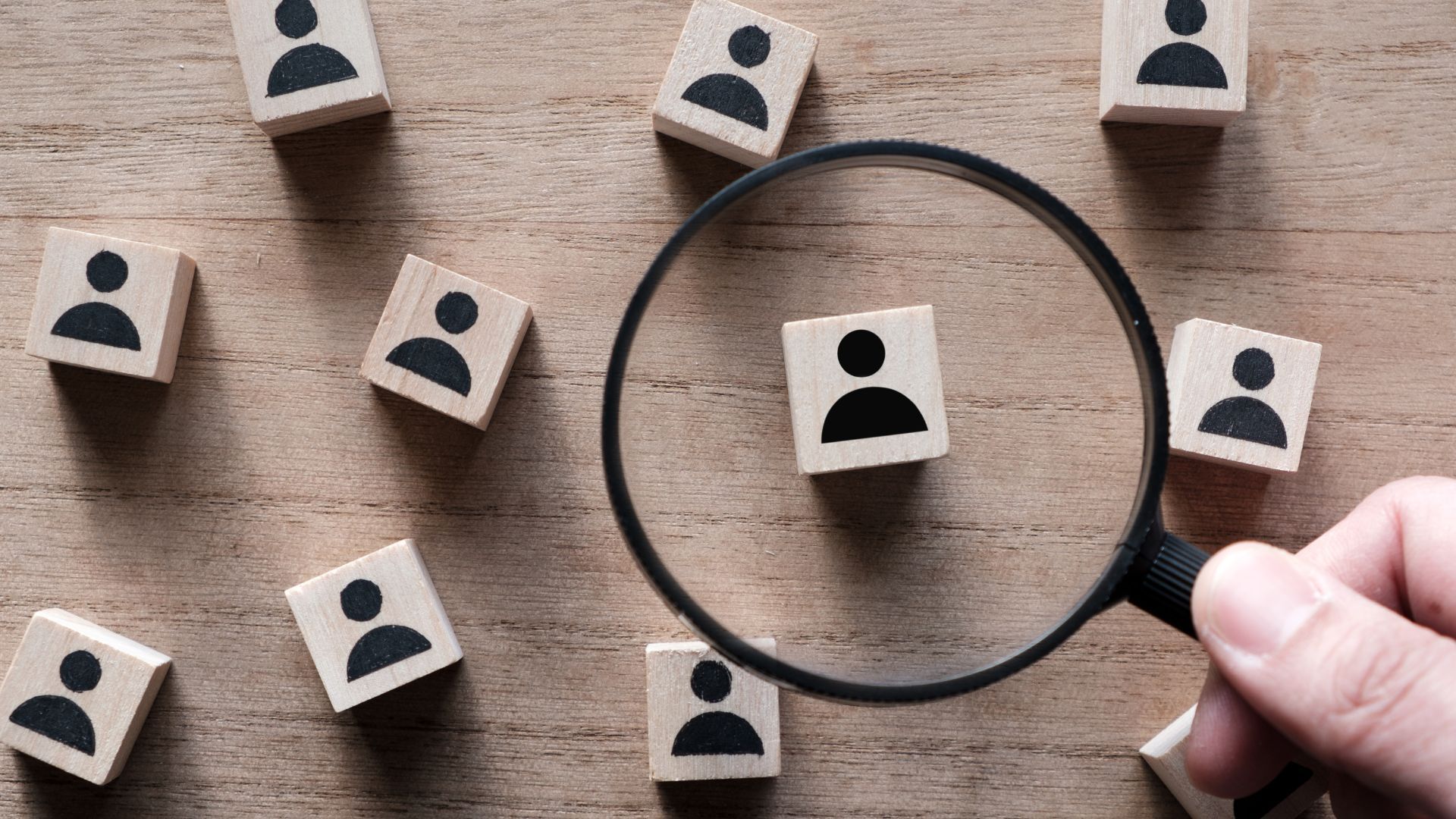 Magnifying glass highlighting a candidate among a group