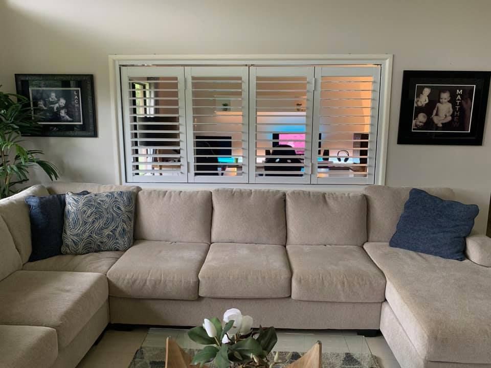 Beige Sectional Sofa in a Living Room, With Shutters on the Window — Innisfail Glass & Aluminium in Innisfail, QLD
