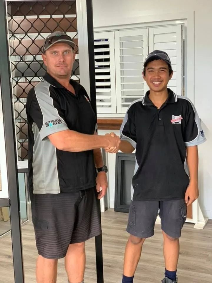 Two Men Shaking Hands in a Showroom — Innisfail Glass & Aluminium in Innisfail, QLD