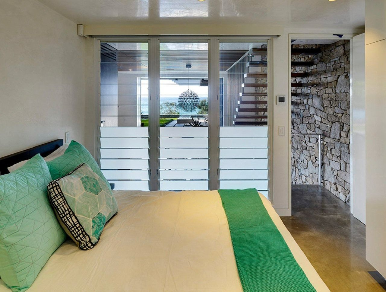 Bedroom With Bed, Teal Pillows and Blanket — Innisfail Glass & Aluminium in Innisfail, QLD