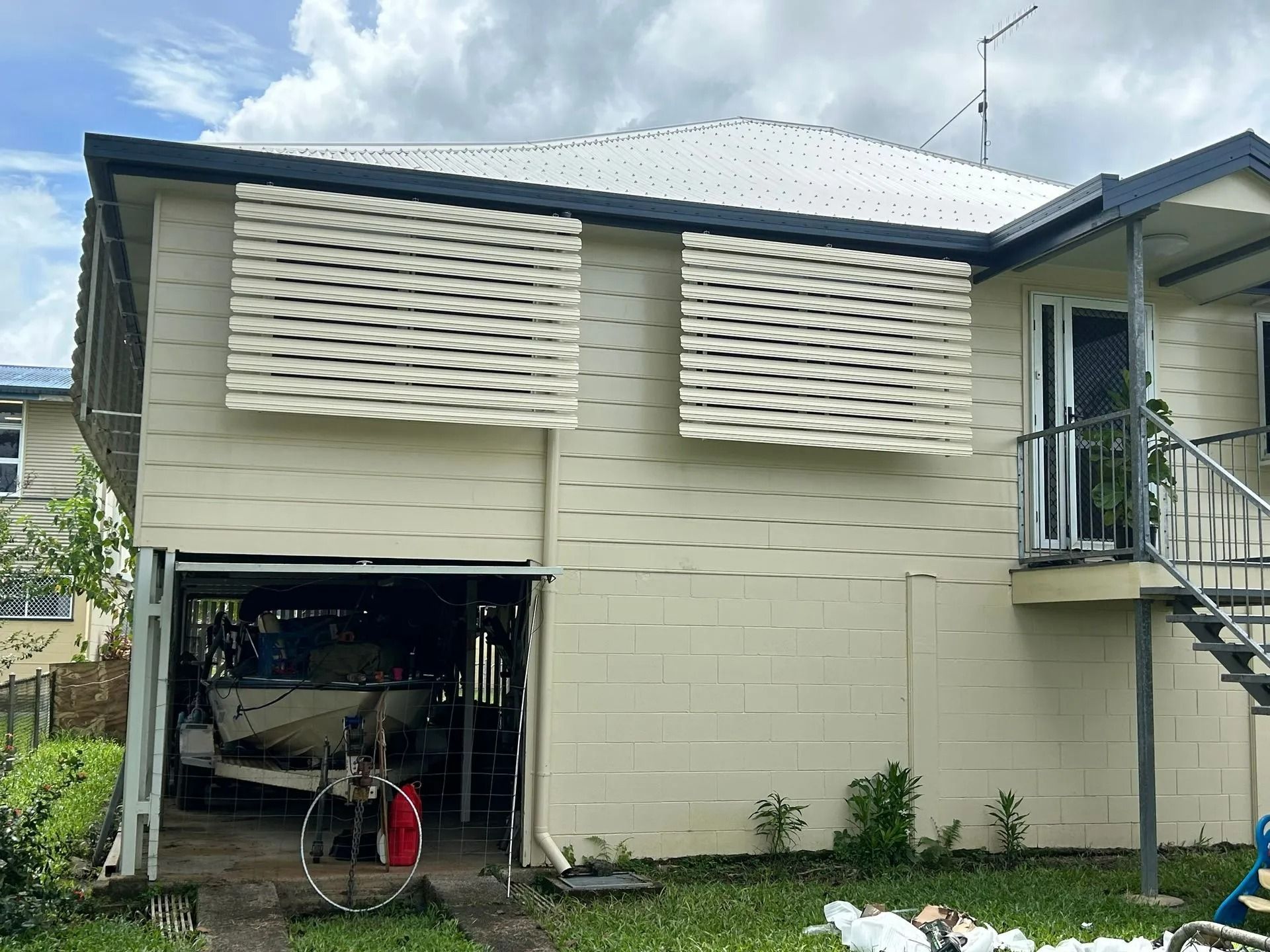 Beige Two-story House With Garage Door Open — Innisfail Glass & Aluminium in Innisfail, QLD