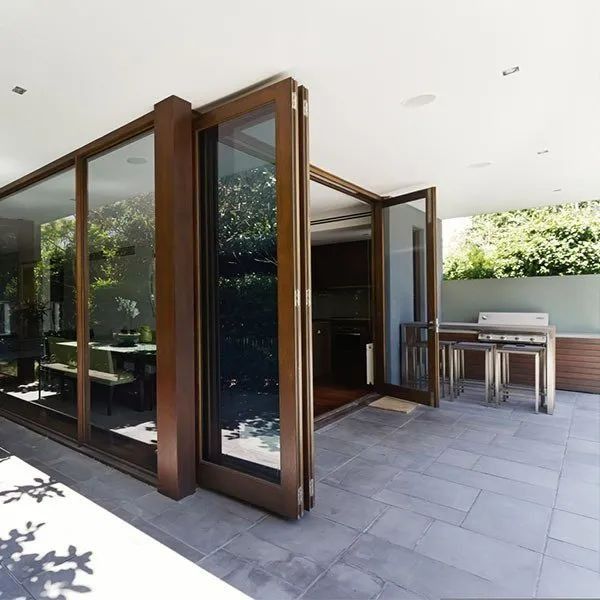 Patio With Large Glass Doors Open to a Kitchen — Innisfail Glass & Aluminium in Innisfail, QLD