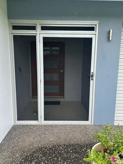 White Framed Screen Door With a Sidelight and Transom, Gray Stone Patio — Innisfail Glass & Aluminium in Innisfail, QLD