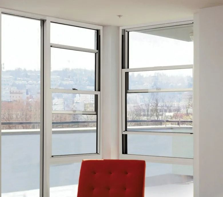 White-framed Double-hung Windows Offer a View of a City — Innisfail Glass & Aluminium in Innisfail, QLD
