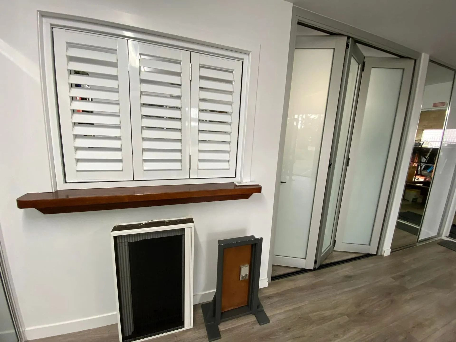 White Shutters and Folding Doors Displayed in a Showroom — Innisfail Glass & Aluminium in Innisfail, QLD