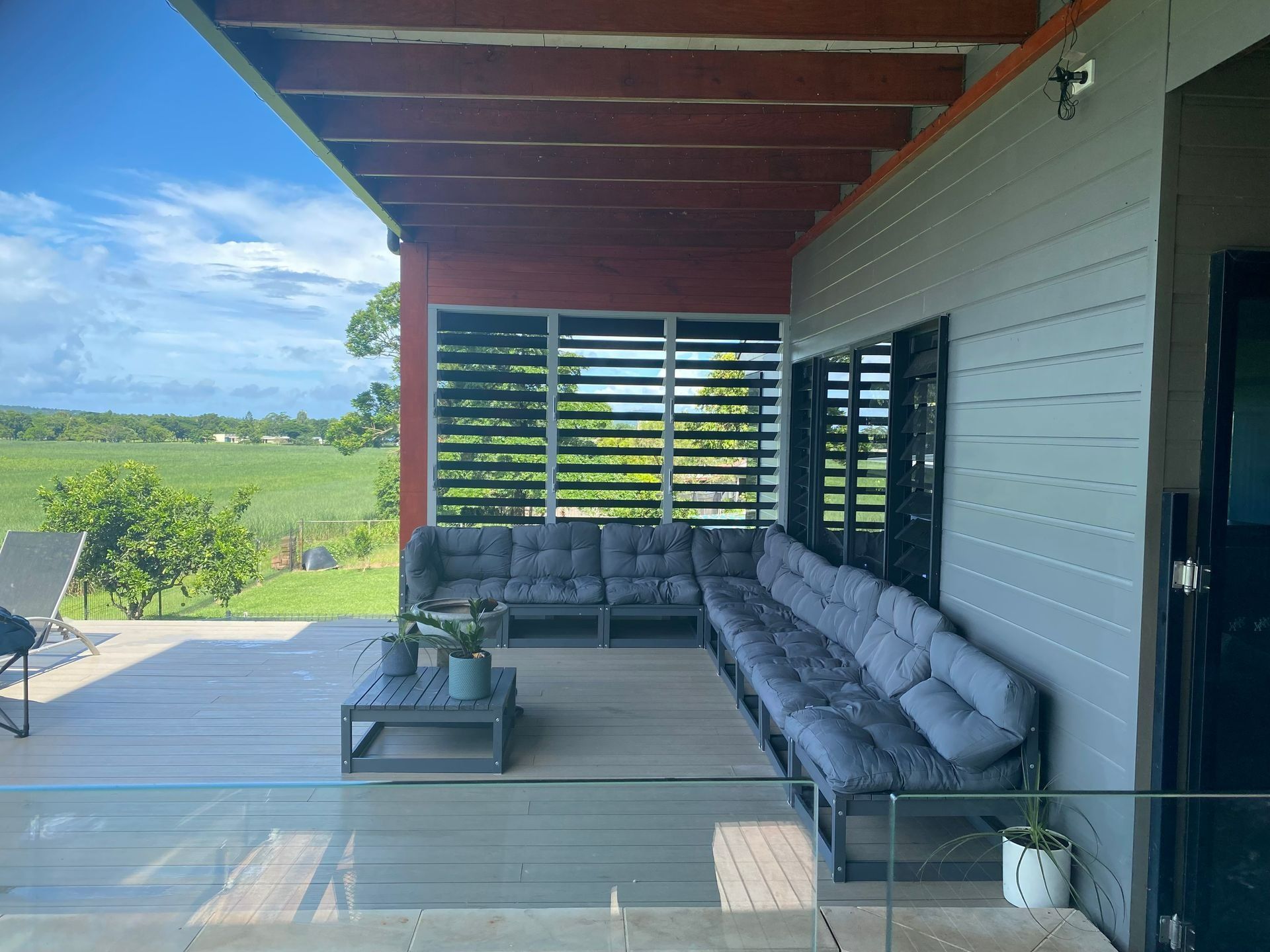 Outdoor Patio With Gray Couches — Innisfail Glass & Aluminium in Innisfail, QLD
