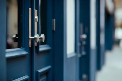 A close up of a blue door with a silver handle.