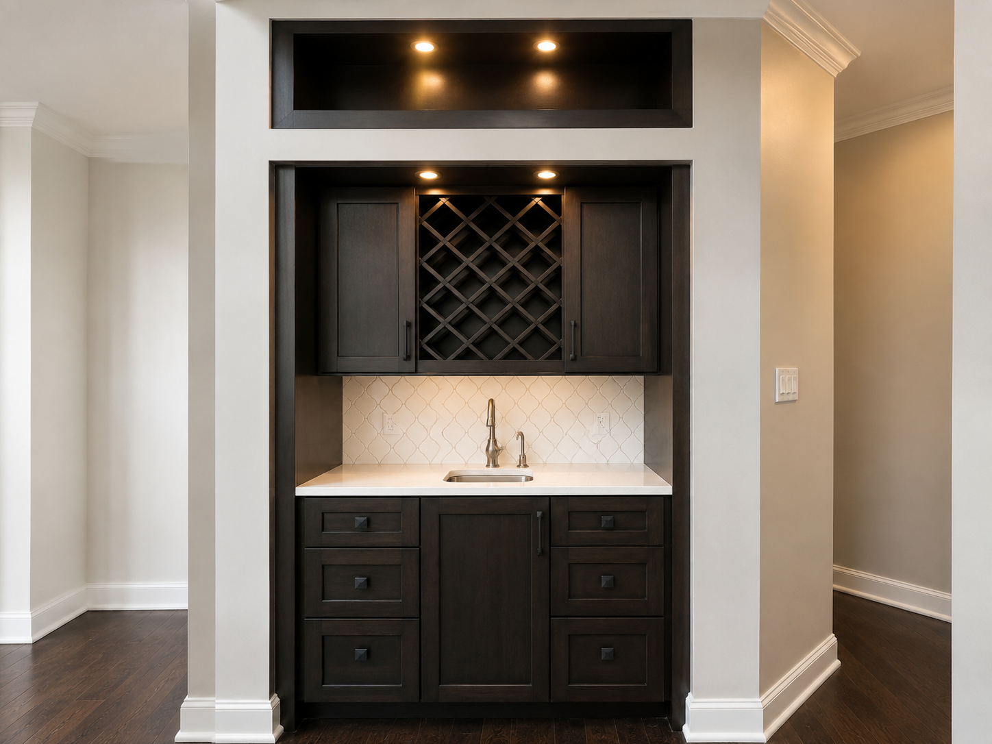 Built-in wet bar with dark cabinetry, wine rack, white countertop, and recessed lighting in a hallway alcove