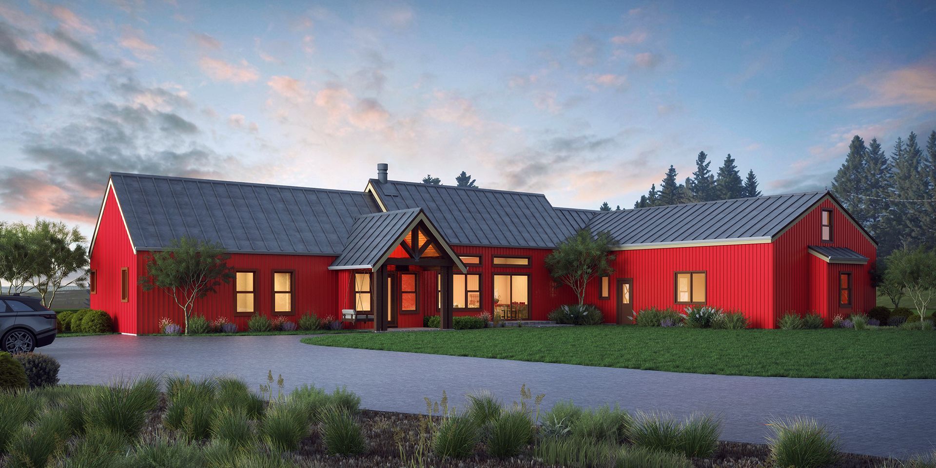 A vibrant red, single-story modern farmhouse with a dark metal roof, set against a sunset sky with a paved driveway.