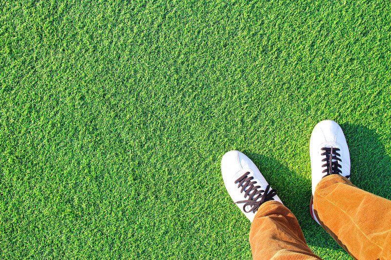 man standing on synthetic grass in Orange County