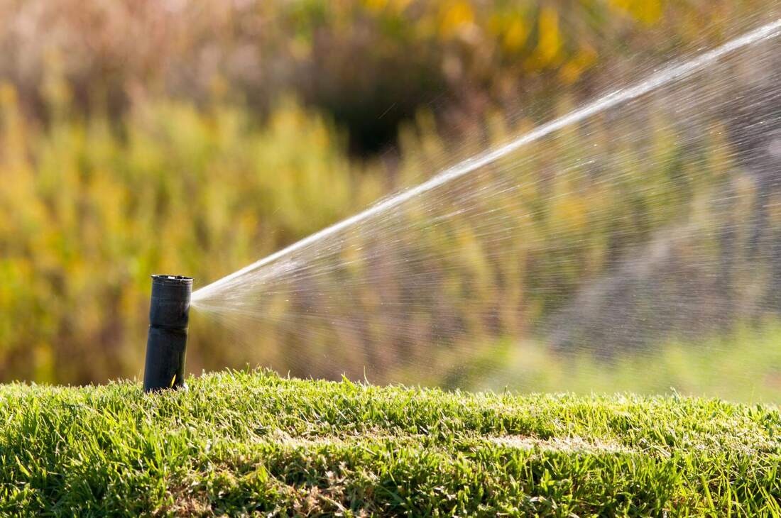 sprinklers watering lawn in Orange County