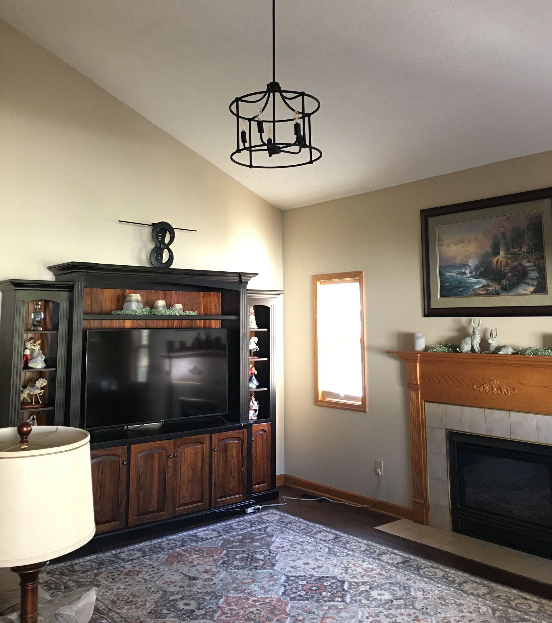 A living room with a fireplace and a flat screen tv