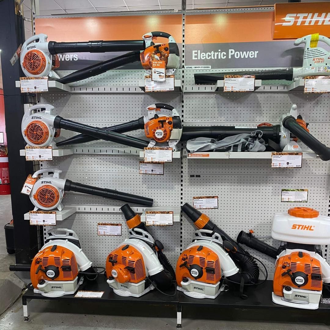 Display of Orange and Black Stihl Electric Power Hedge Trimmers and Blowers on a Pegboard Wall — Casali's in Mareeba, QLD