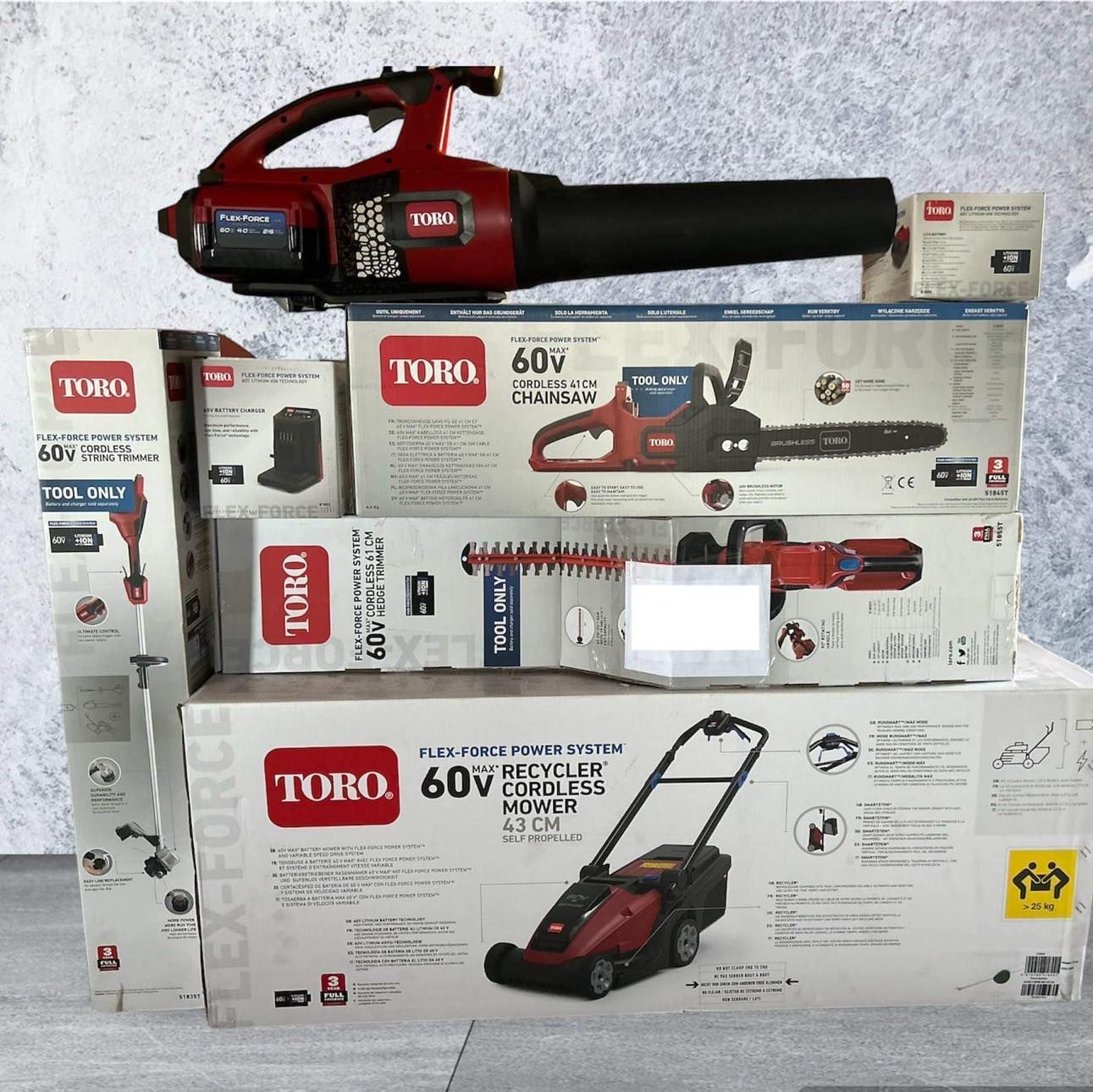 Stacked Toro 60v Lawn Tool Boxes With a Red-and-black Blower on Top Against a White Background — Casali's in Mareeba, QLD