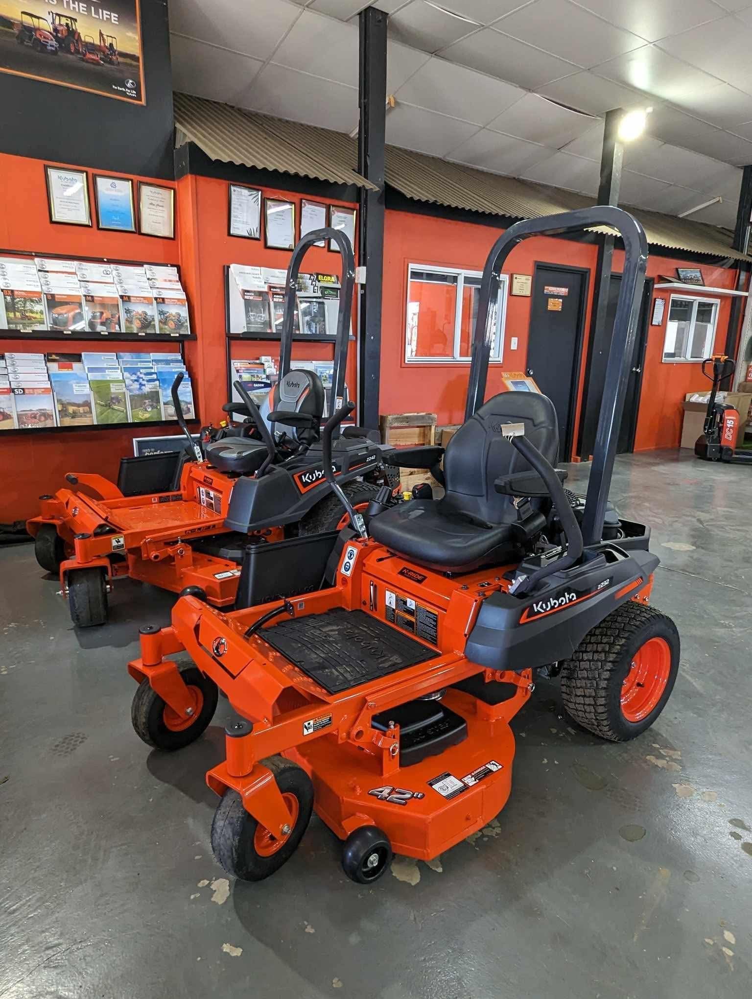 Orange Zero-turn Lawn Mowers Displayed in a Showroom With Brochures and Tools on the Wall — Casali's in Mareeba, QLD