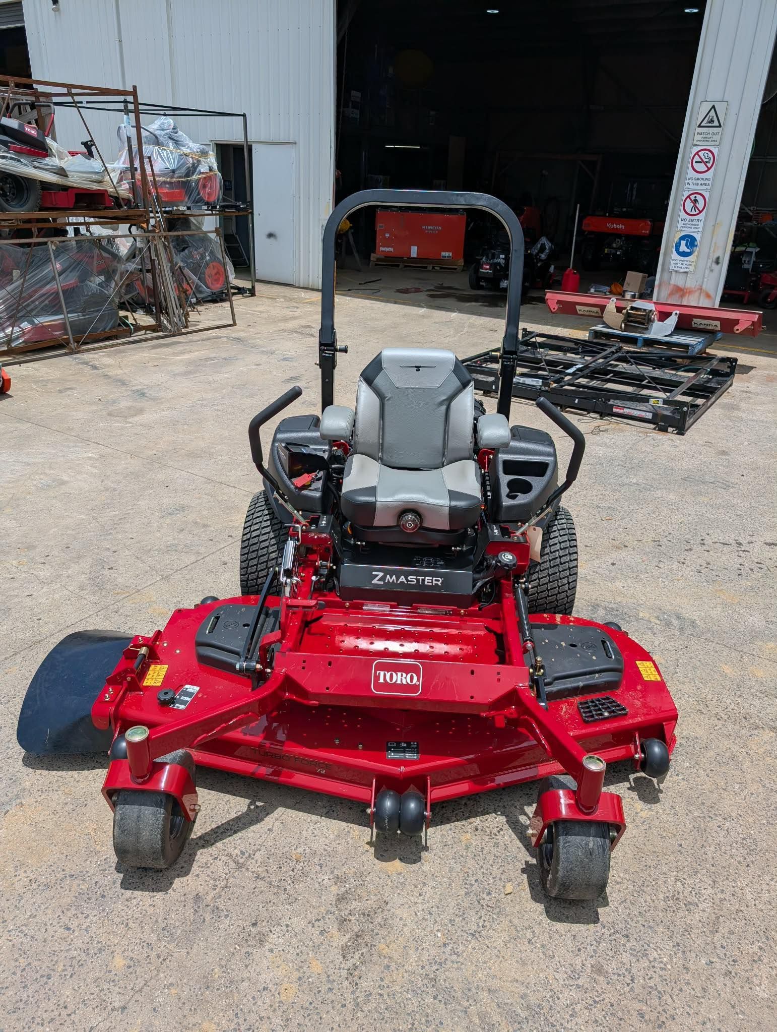 Red Riding Lawn Mower Parked Outside a Workshop, Facing the Camera — Casali's in Mareeba, QLD