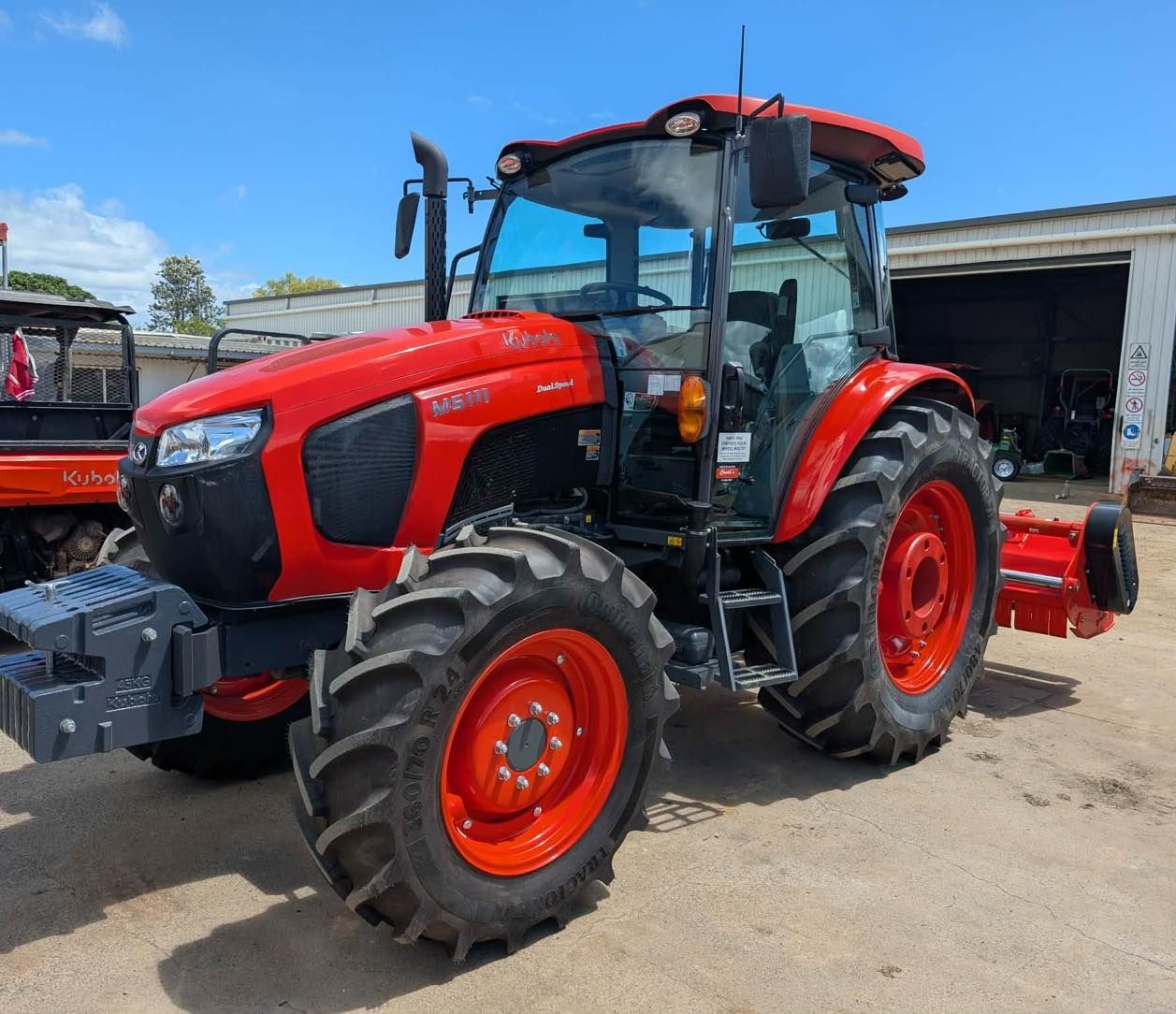 Red Tractor Parked Outside a Workshop, Facing the Camera — Casali's in Mareeba, QLD