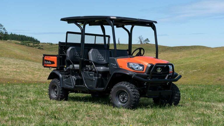 Orange and black utility vehicle on grass in a hilly field — Casali's in Mareeba, QLD