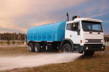 White Water Truck Spraying Water on a Grassy Field at Dusk — Casali's in Mareeba, QLD