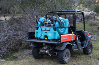 Blue Off-road Utility Vehicle Parked in Brush, Carrying a Turquoise Pump and Hoses in the Back — Casali's in Mareeba, QLD